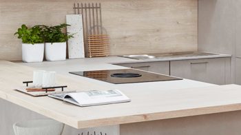 Einbauküche Nobilia® aus Holz in Holzfarben Hell nobilia® Einbauküche Riva mit JUNKER Elektrogeräten und Esstheke Beton Sand & Eiche Montreal - Stellfläche ca. 304 x 319 cm