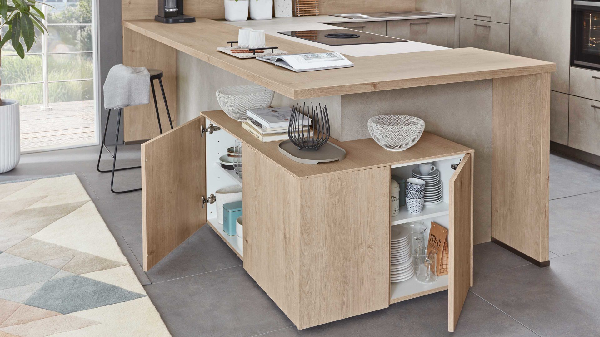 Einbauküche Nobilia® aus Holz in Holzfarben Hell nobilia® Einbauküche Riva mit JUNKER Elektrogeräten und Esstheke Beton Sand & Eiche Montreal - Stellfläche ca. 304 x 319 cm